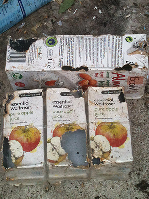 Rat damage to cartons of juice.